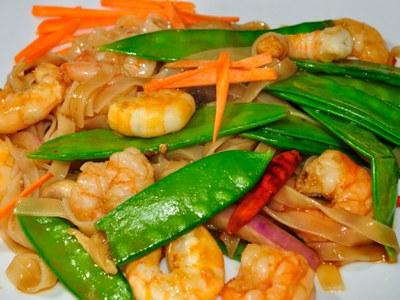 Close up of plated shrimp and snow pea stir fry