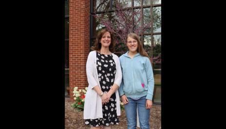 Elizabeth Krause and Dr. Thompson stand in front of Loftsgard Hall