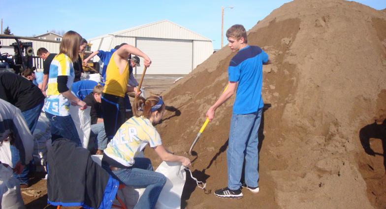 youth filling sandbags