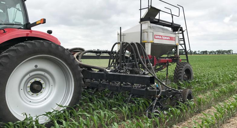 red tractor in field with cover crops