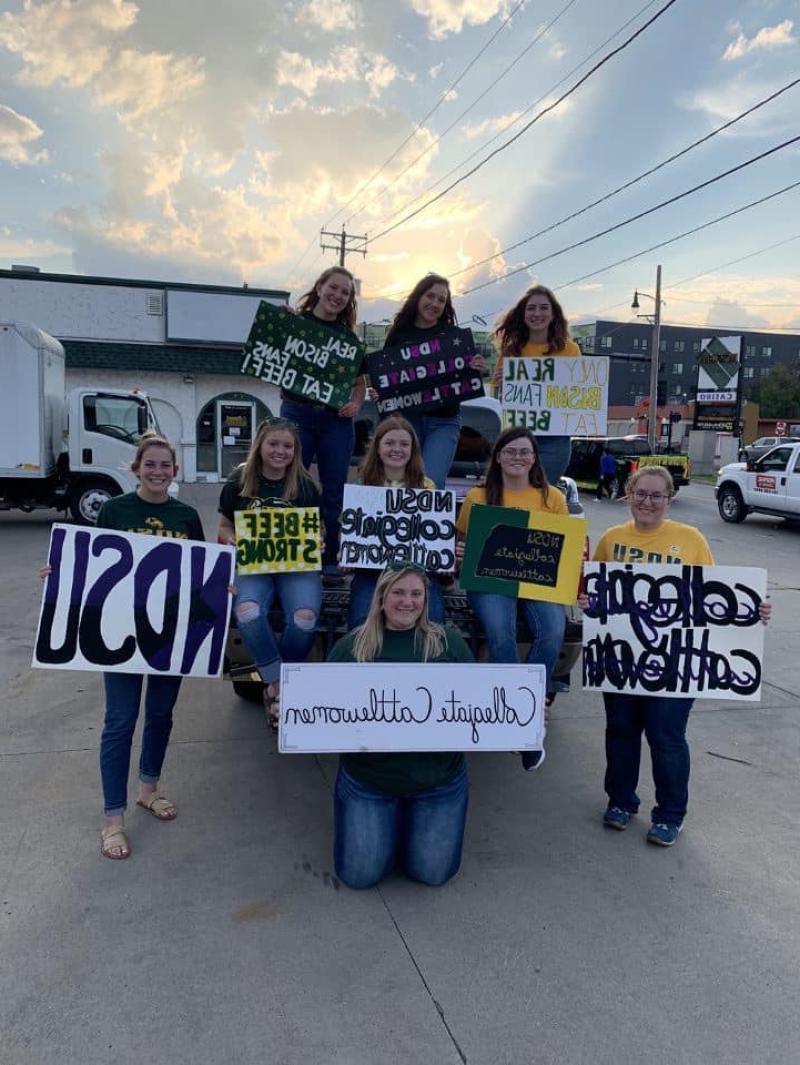 Collegiate Cattlewomen posing with NDSU signs